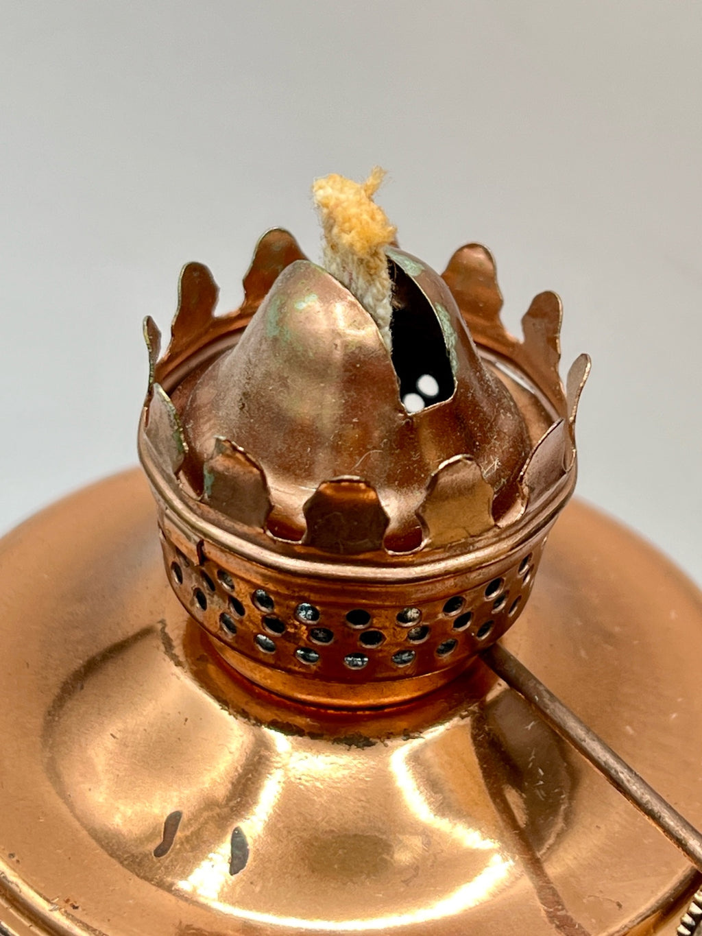 A vintage copper miniature chamber oil lamp featuring a round dish saucer base with a finger loop handle and a crown burner gallery with cotton wick. - Photo 4