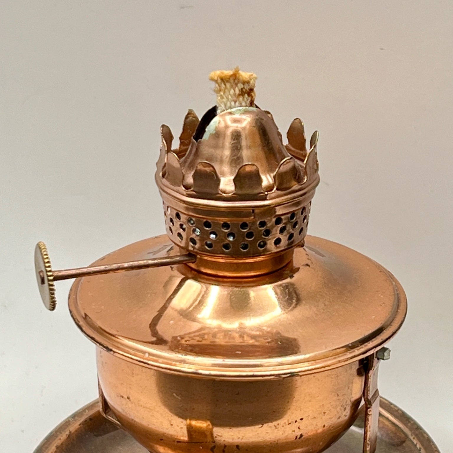 A vintage copper miniature chamber oil lamp featuring a round dish saucer base with a finger loop handle and a crown burner gallery with cotton wick. - Photo 7