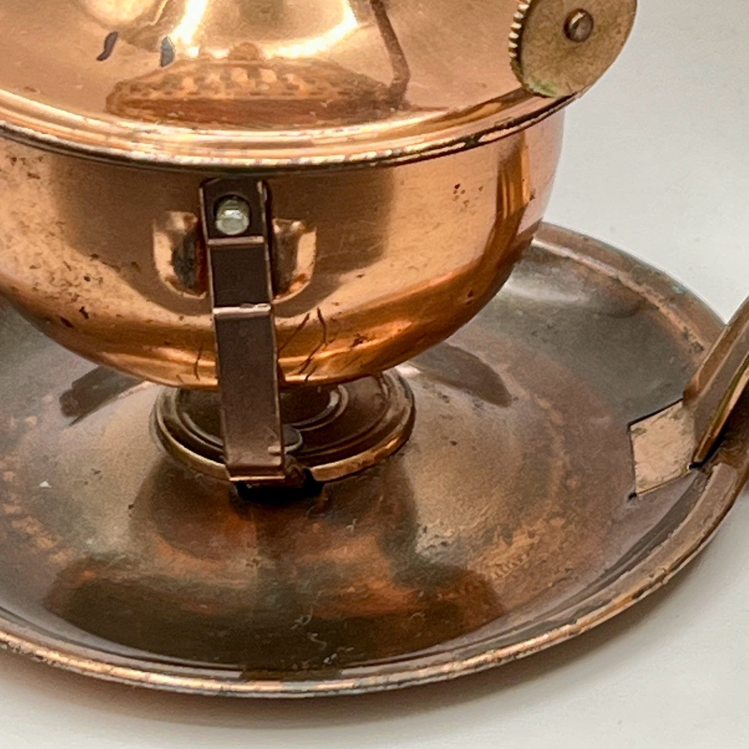 A vintage copper miniature chamber oil lamp featuring a round dish saucer base with a finger loop handle and a crown burner gallery with cotton wick. - Photo 8