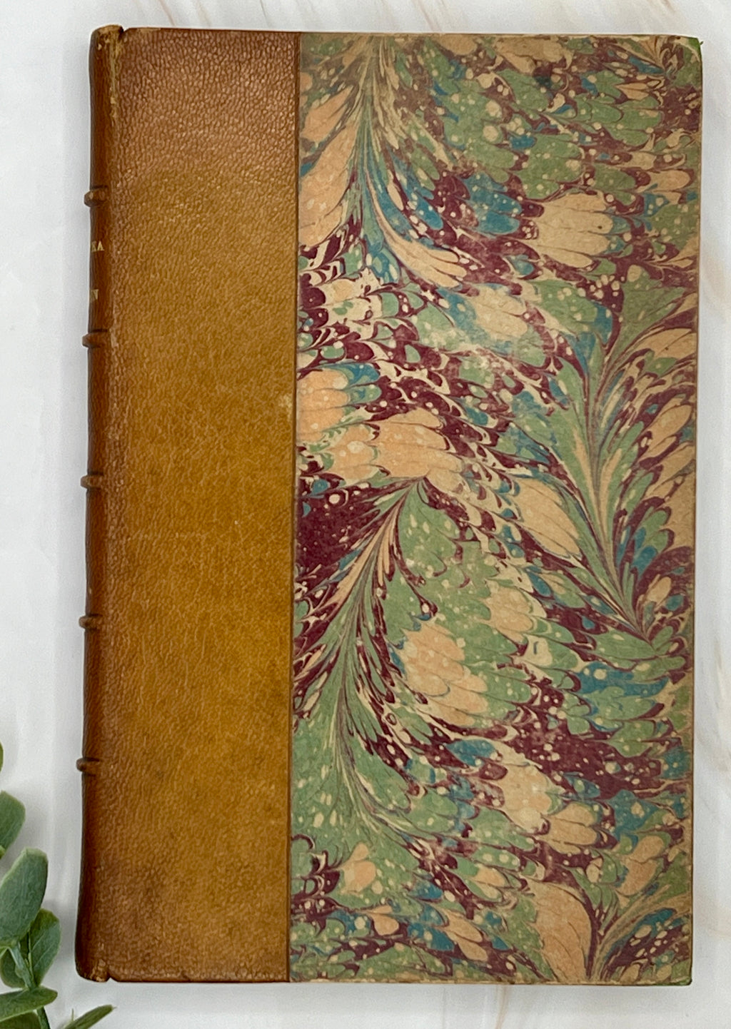 Antique leather bound volume with tan leather spine, raised ribs, and vibrant green, plum, and cream peacock combed marbled paper over hard boards. - Photo 1