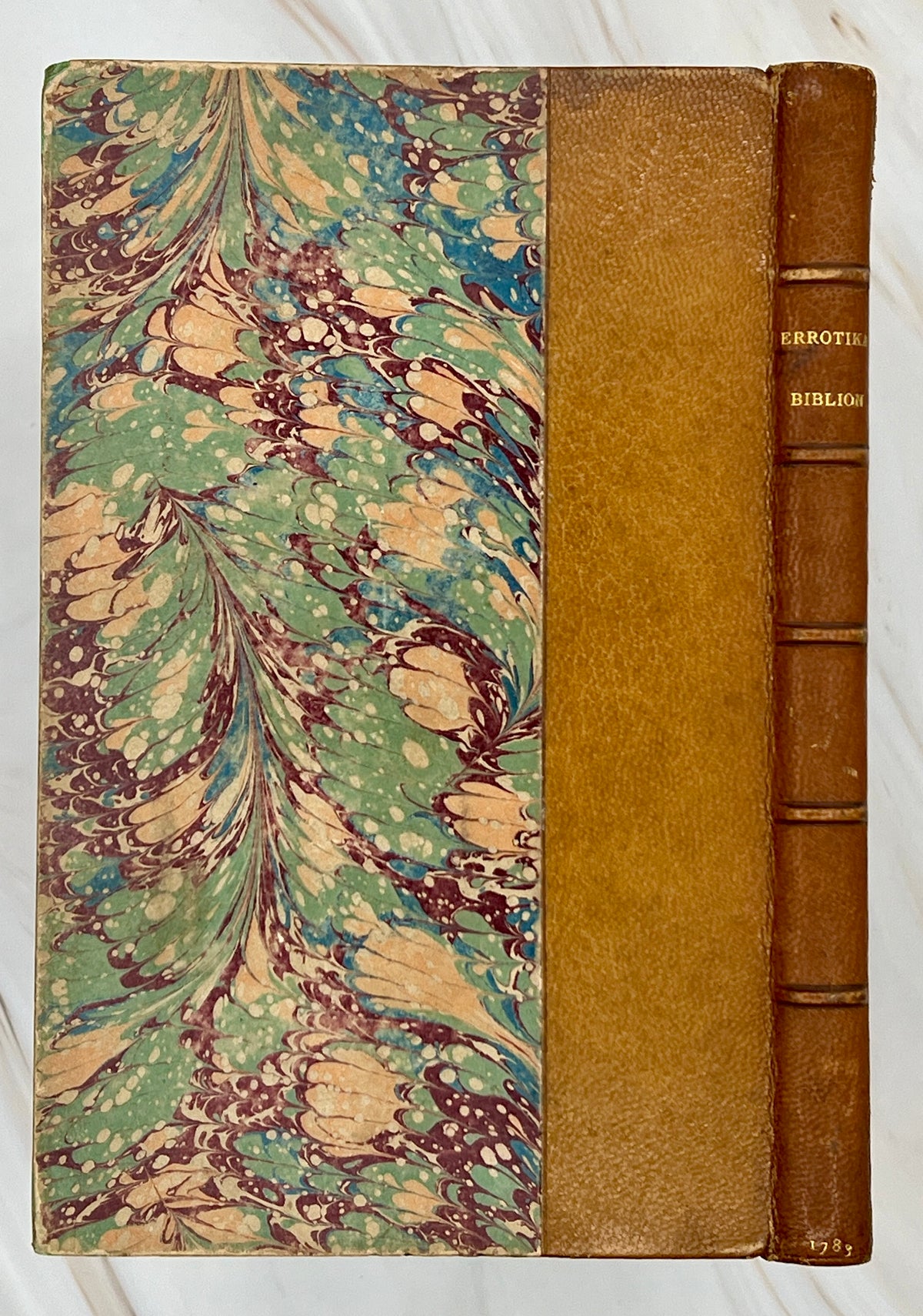 Antique leather bound volume with tan leather spine, raised ribs, and vibrant green, plum, and cream peacock combed marbled paper over hard boards. - Photo 2