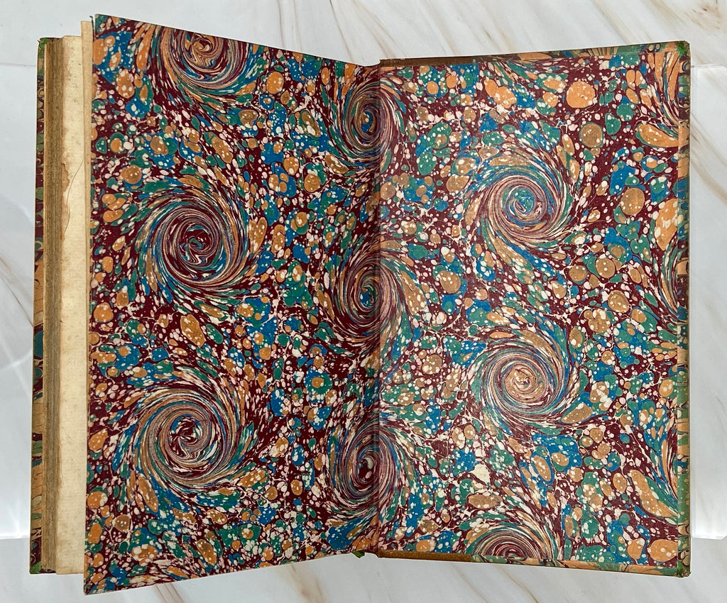 Antique leather bound volume with tan leather spine, raised ribs, and vibrant green, plum, and cream peacock combed marbled paper over hard boards. - Photo 11