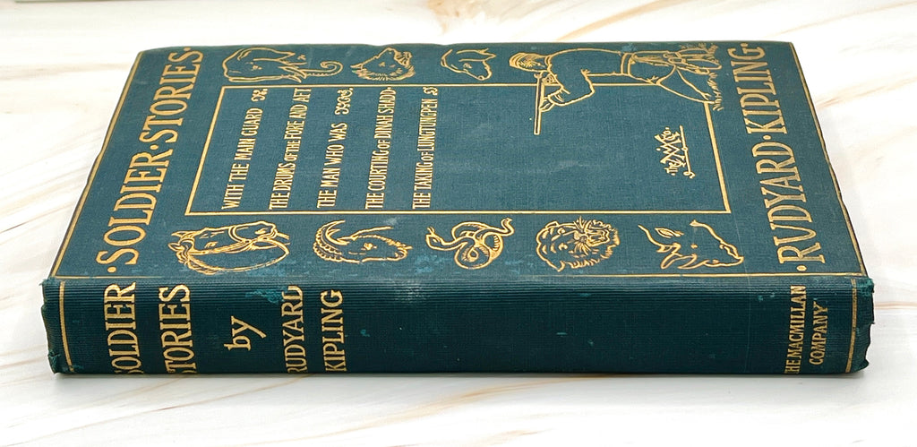 Dark green cloth hardcover book titled Soldier Stories by Rudyard Kipling featuring elaborate gilt embossed lettering, framed story titles, and wildlife illustrations. - Photo 2