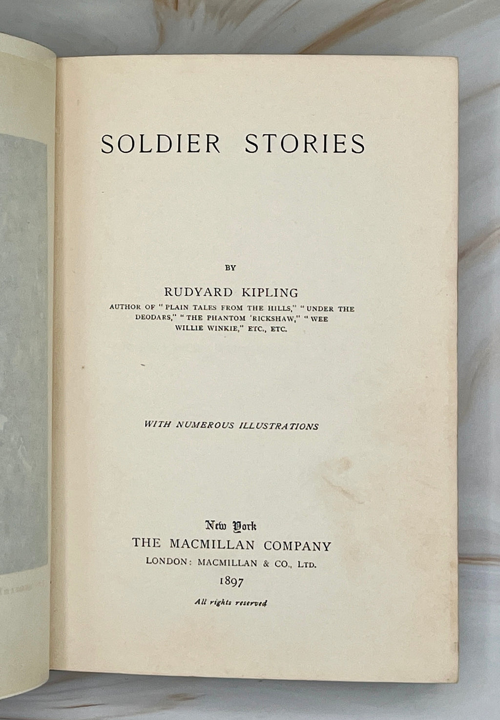 Dark green cloth hardcover book titled Soldier Stories by Rudyard Kipling featuring elaborate gilt embossed lettering, framed story titles, and wildlife illustrations. - Photo 4
