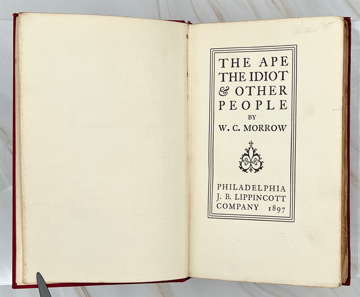 Antique red cloth hardcover book titled The Ape, the Idiot & Other People by W. C. Morrow, featuring an ornate gilt-stamped mythical dragon and gold lettering. - Photo 5
