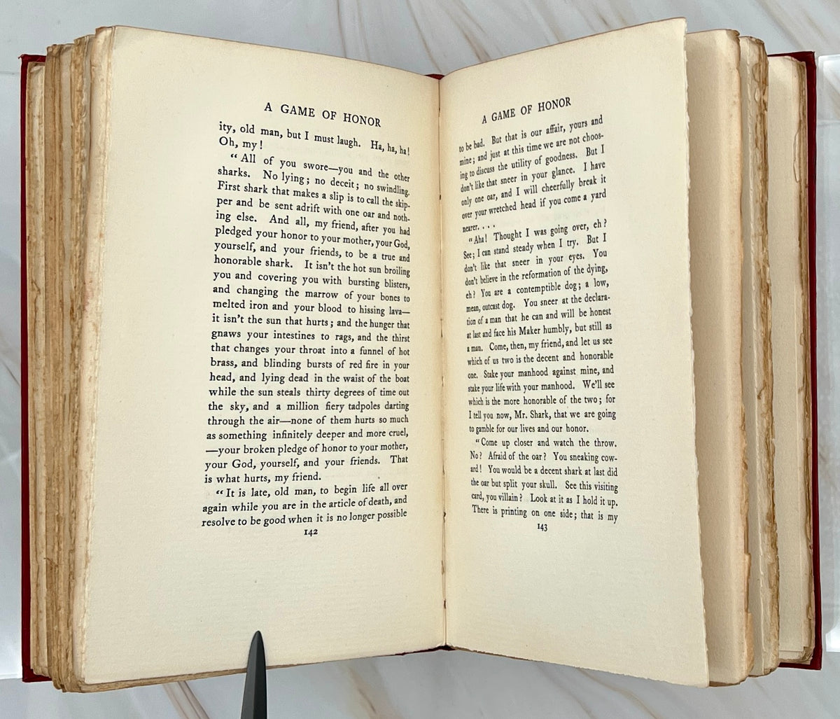 Antique red cloth hardcover book titled The Ape, the Idiot & Other People by W. C. Morrow, featuring an ornate gilt-stamped mythical dragon and gold lettering. - Photo 7