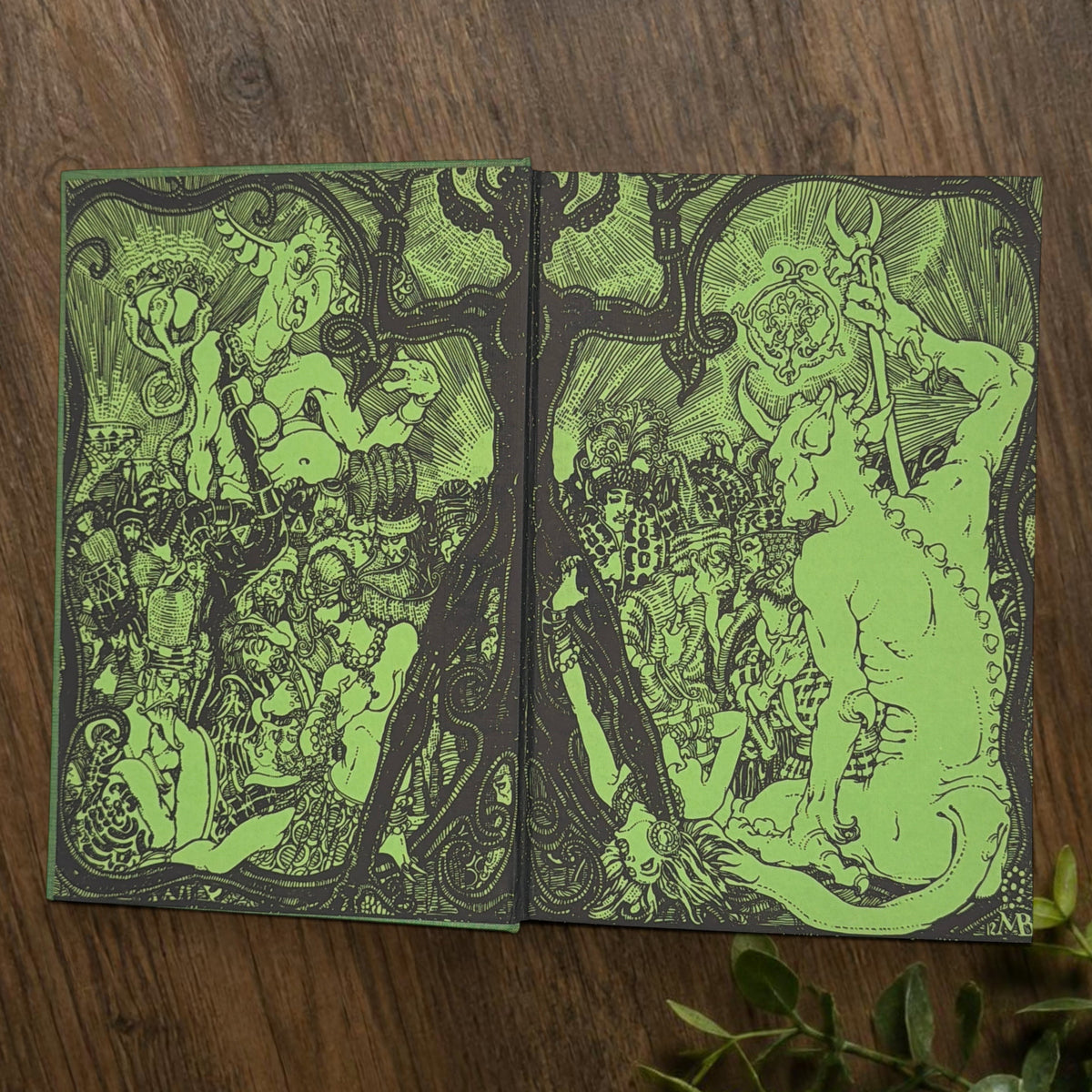 Front cover of the 1928 hardcover edition of Vathek bound in textured green book cloth, resting upright on a dark natural wood surface. - Photo 4