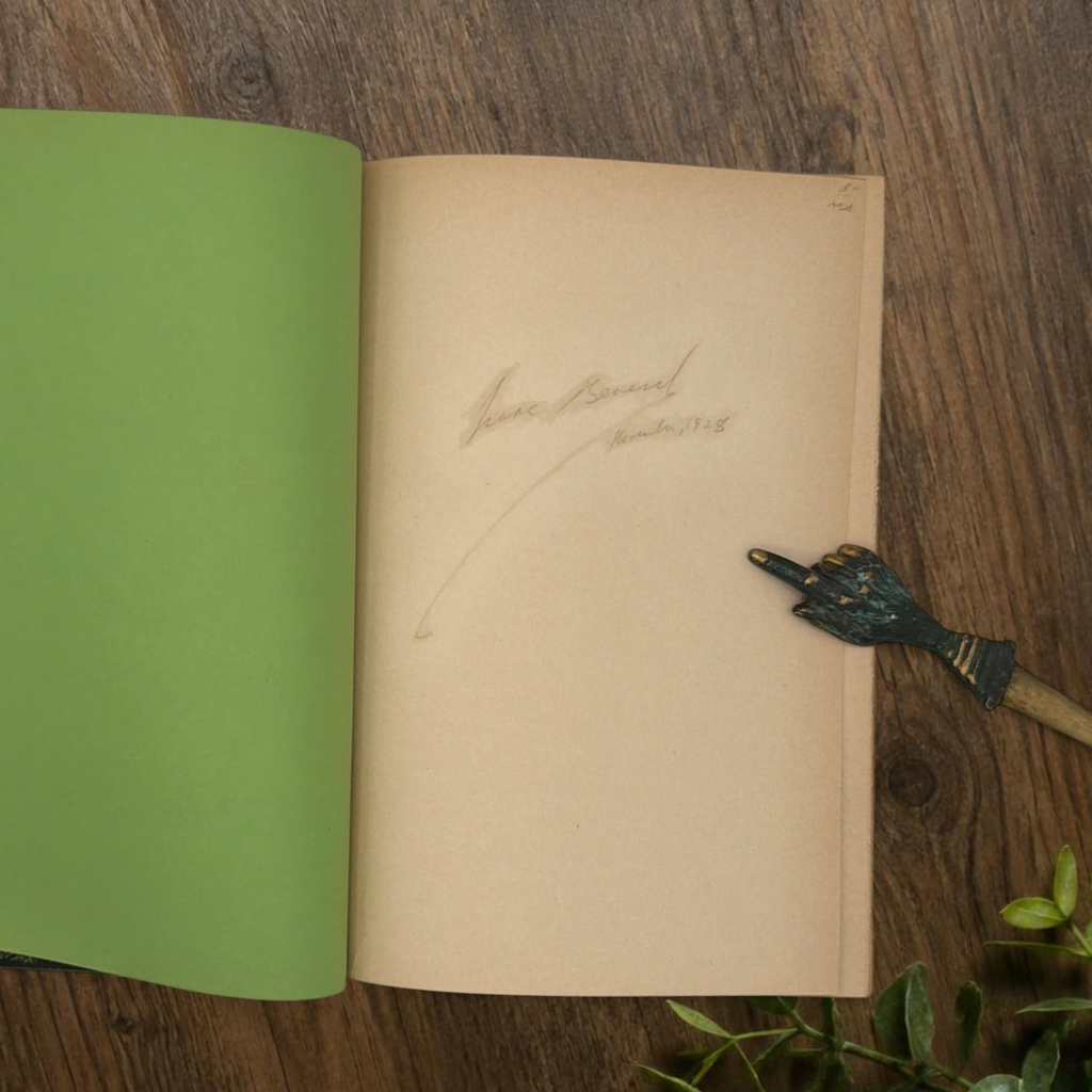 Front cover of the 1928 hardcover edition of Vathek bound in textured green book cloth, resting upright on a dark natural wood surface. - Photo 5