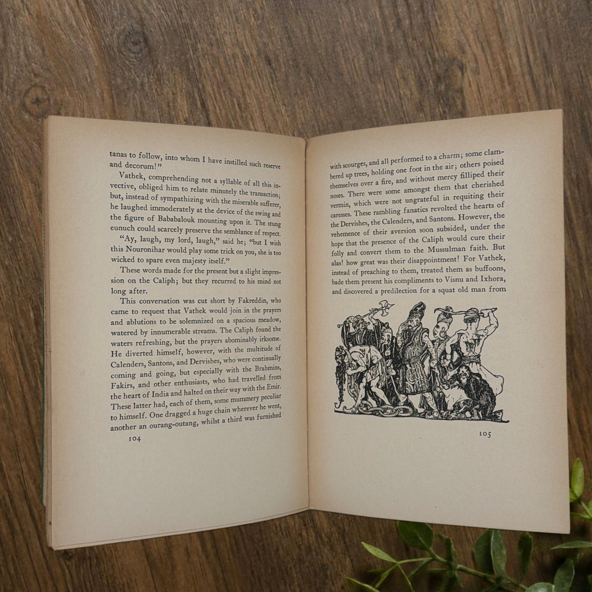 Front cover of the 1928 hardcover edition of Vathek bound in textured green book cloth, resting upright on a dark natural wood surface. - Photo 9