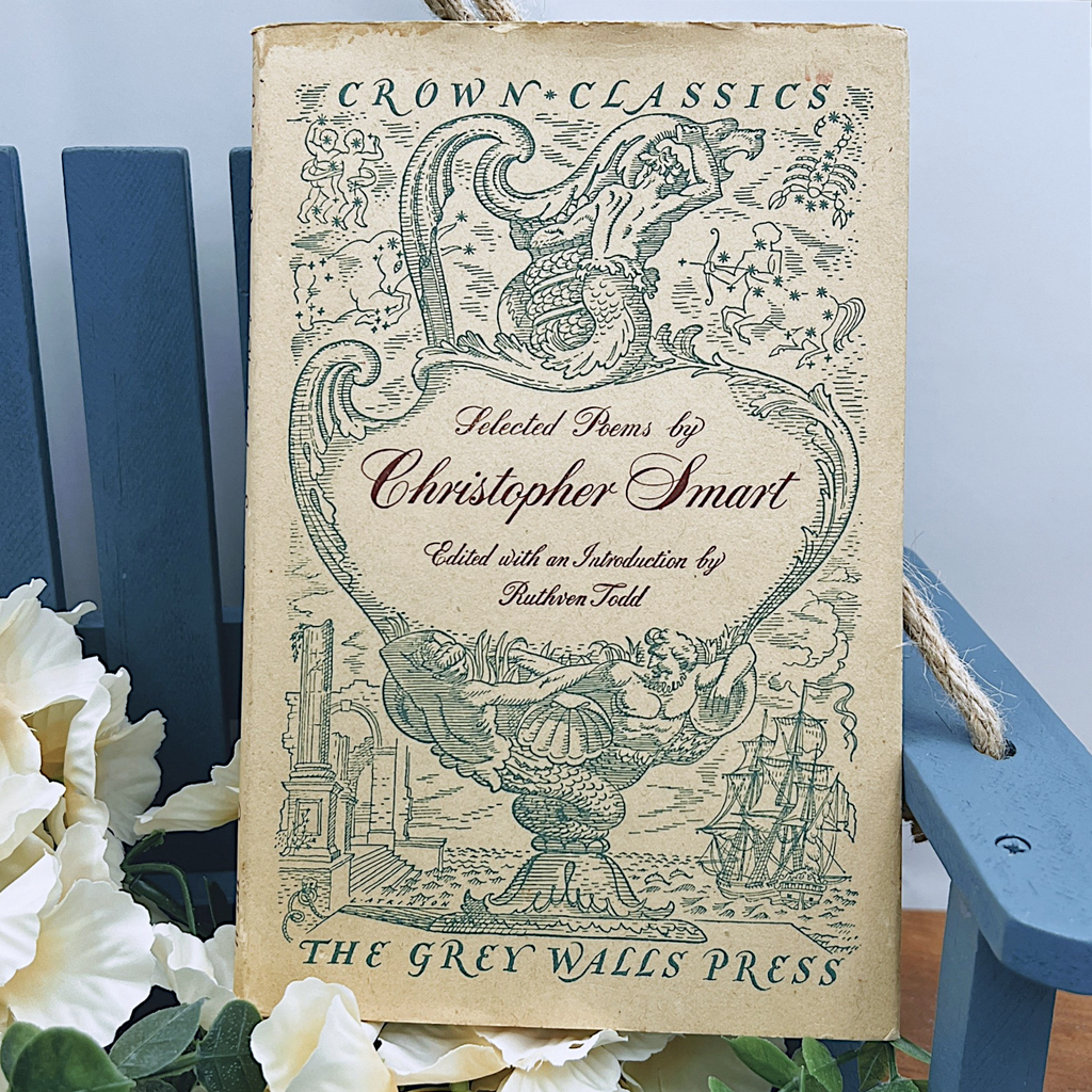 An open vintage Crown Classics edition of Christopher Smart's poem A Song to David, showing printed stanzas across cream paper pages on a rustic wooden table. - Photo 1