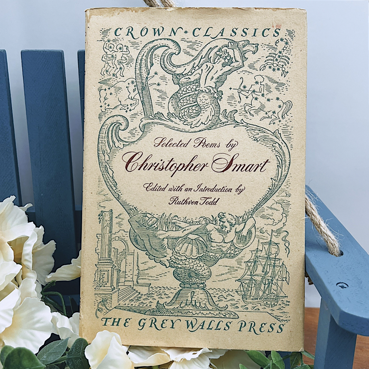 An open vintage Crown Classics edition of Christopher Smart's poem A Song to David, showing printed stanzas across cream paper pages on a rustic wooden table. - Photo 1