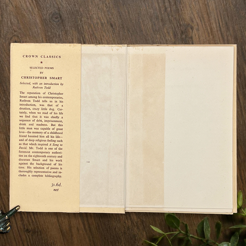 An open vintage Crown Classics edition of Christopher Smart's poem A Song to David, showing printed stanzas across cream paper pages on a rustic wooden table. - Photo 2