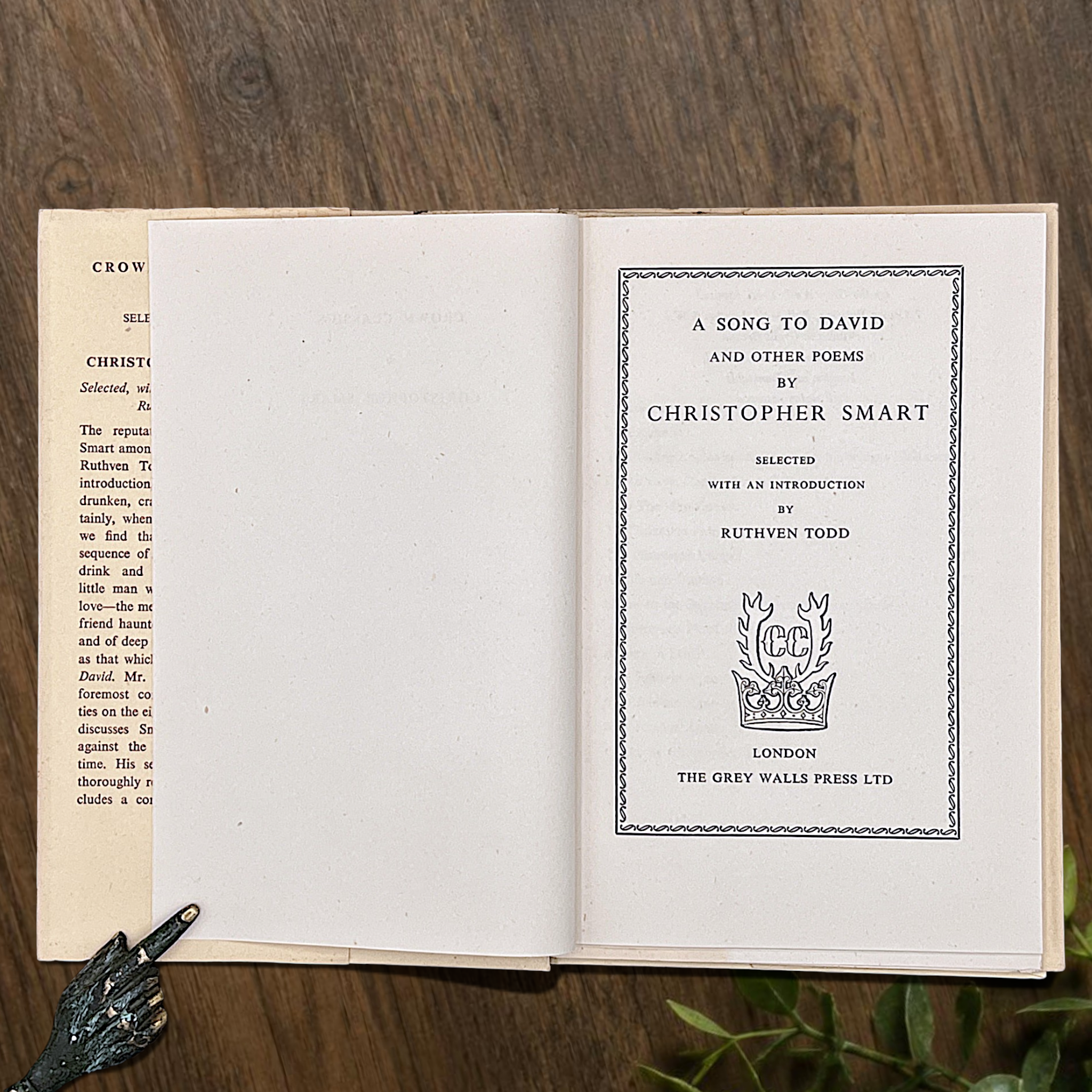 An open vintage Crown Classics edition of Christopher Smart's poem A Song to David, showing printed stanzas across cream paper pages on a rustic wooden table. - Photo 3