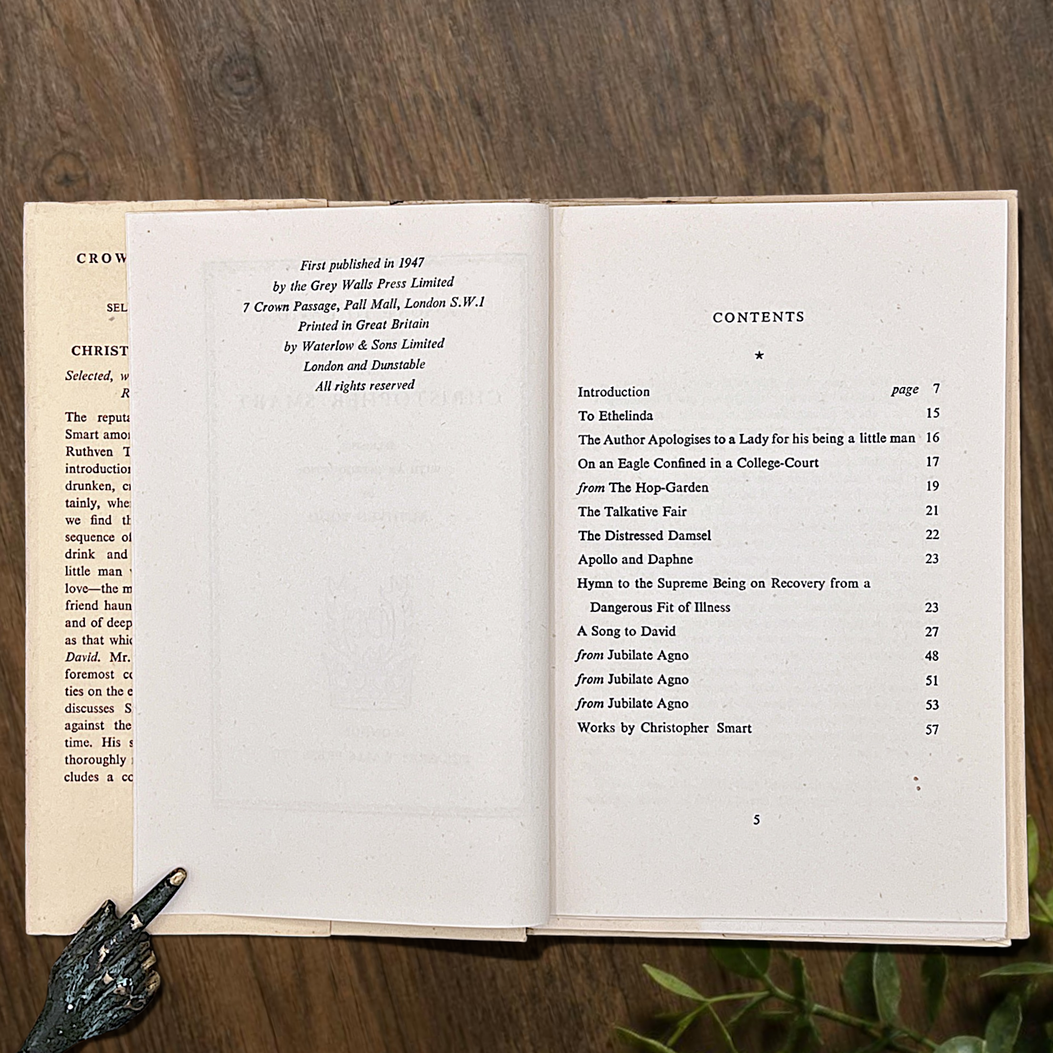 An open vintage Crown Classics edition of Christopher Smart's poem A Song to David, showing printed stanzas across cream paper pages on a rustic wooden table. - Photo 4