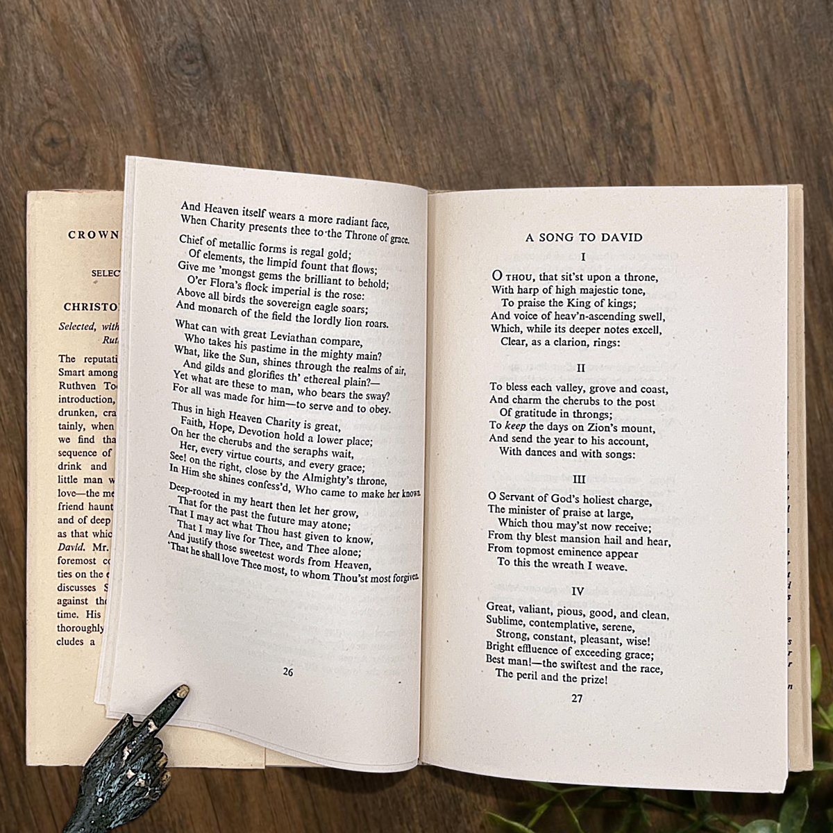An open vintage Crown Classics edition of Christopher Smart's poem A Song to David, showing printed stanzas across cream paper pages on a rustic wooden table. - Photo 5