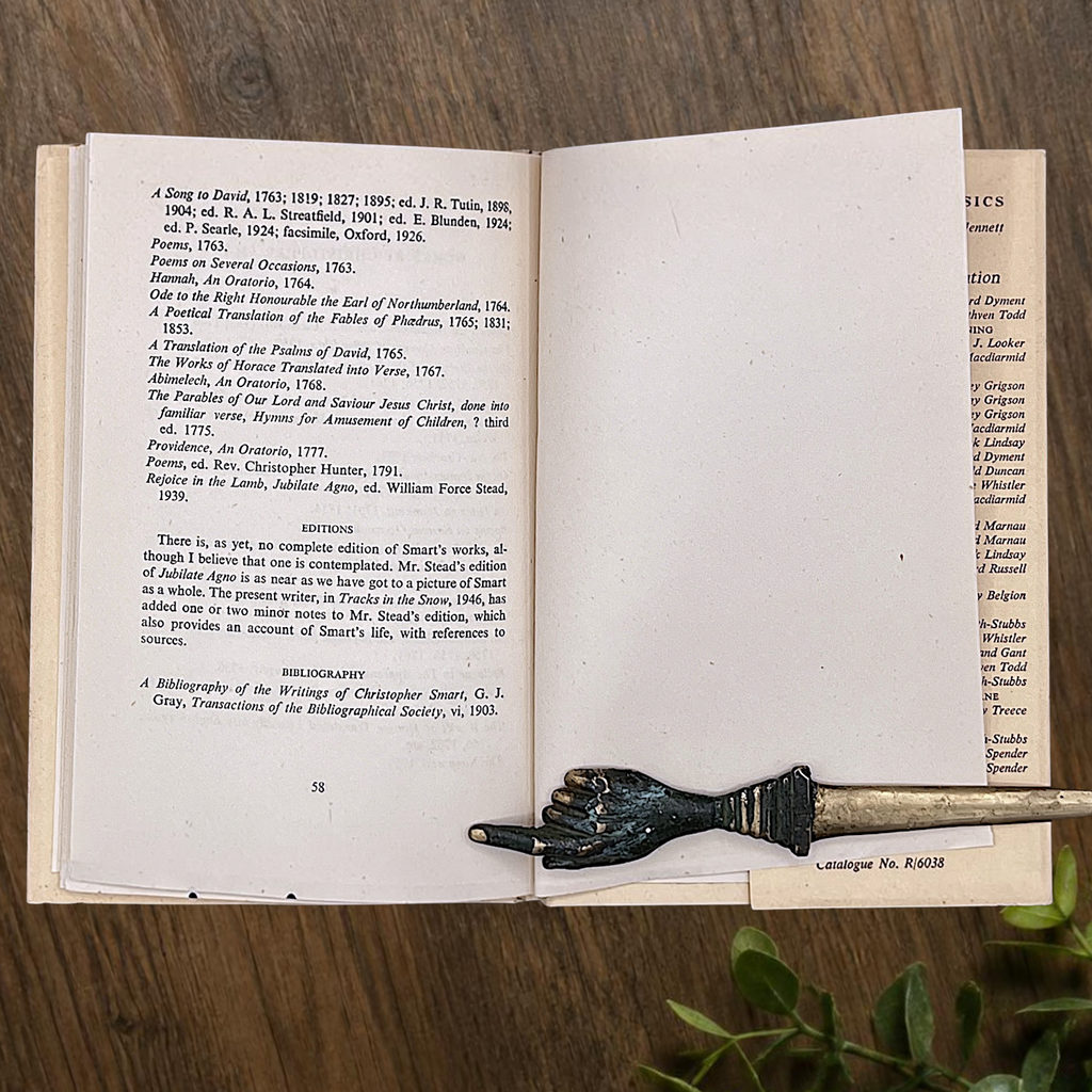 An open vintage Crown Classics edition of Christopher Smart's poem A Song to David, showing printed stanzas across cream paper pages on a rustic wooden table. - Photo 6