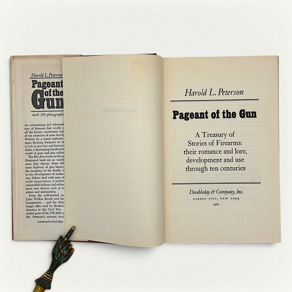 Patina & Prose first edition Pageant of the Gun book open to the title page with dust jacket flap visible