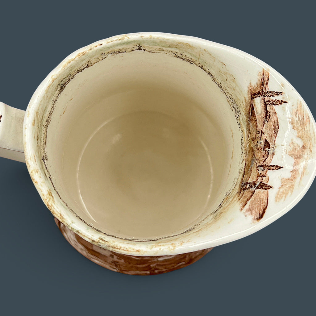 An antique Alfred Meakin brown transferware ceramic pitcher decorated with a detailed countryside landscape and leafy handle motif. - Photo 13