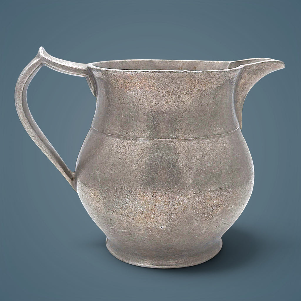 Antique pewter water pitcher in soft gray metal featuring an open flared spout, a bulbous waist with a raised decorative band, and a curved handle. - Photo 1