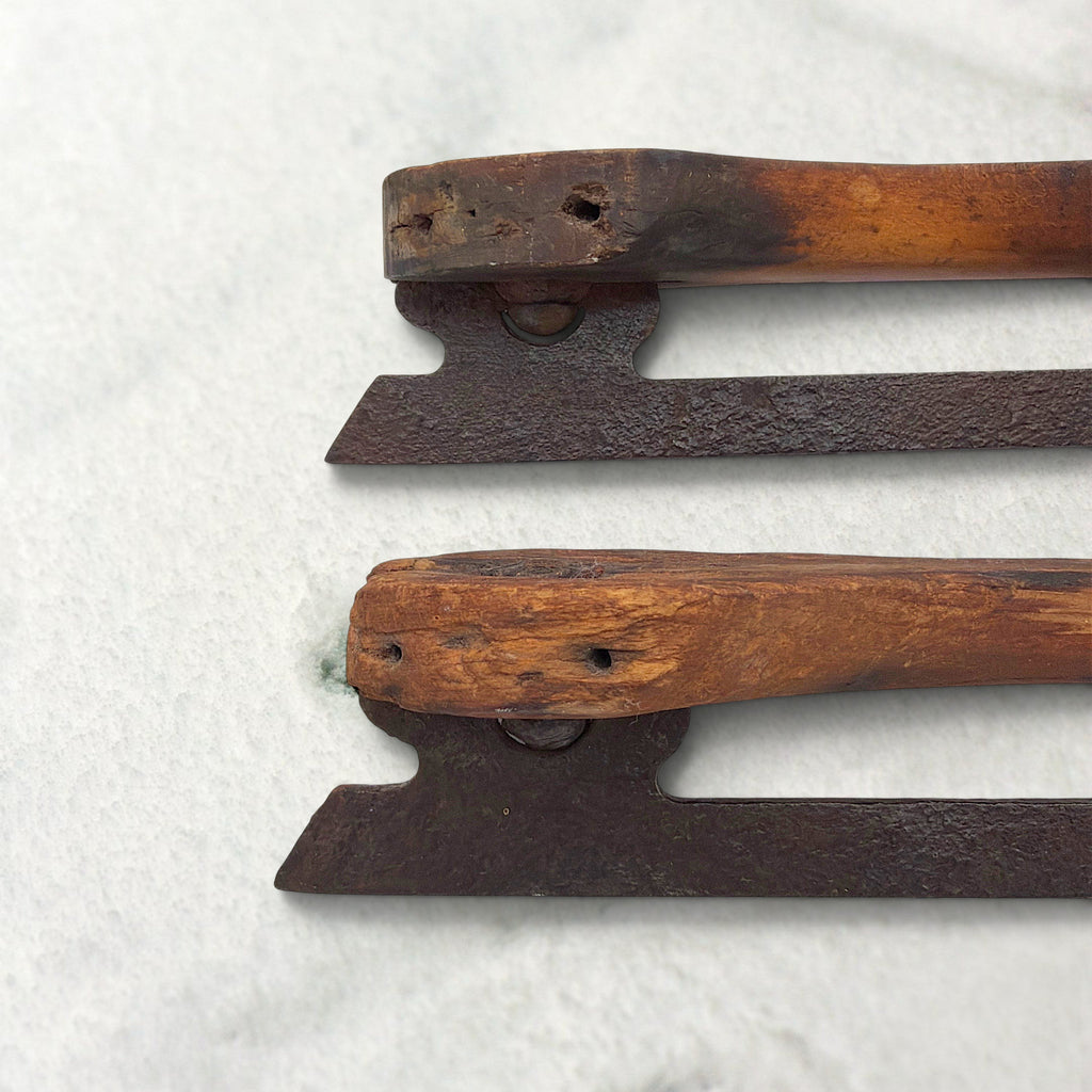 Pair of antique 19th-century hand-carved wood and wrought iron ice skates crossed on snow. - Photo 6
