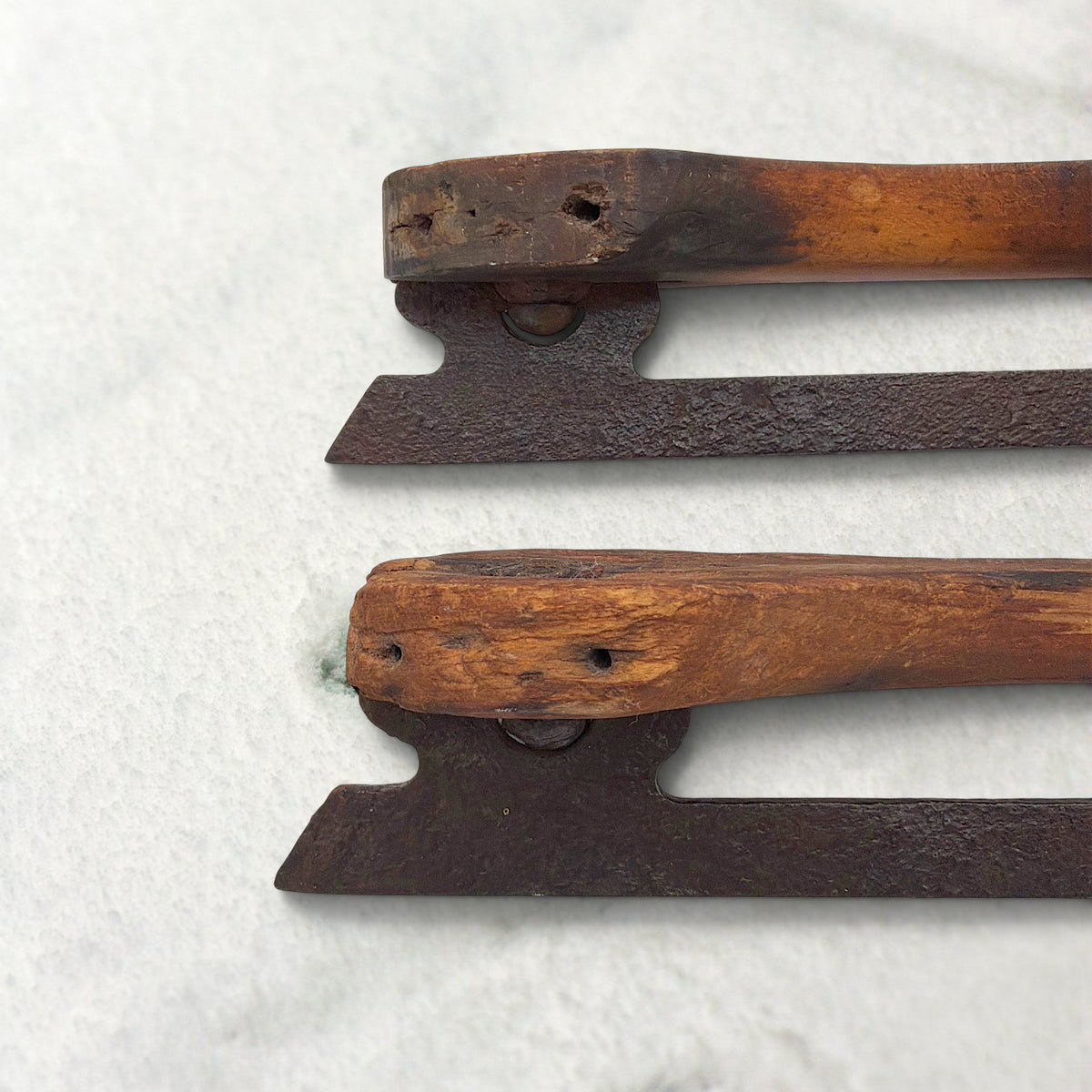 Pair of antique 19th-century hand-carved wood and wrought iron ice skates crossed on snow. - Photo 6