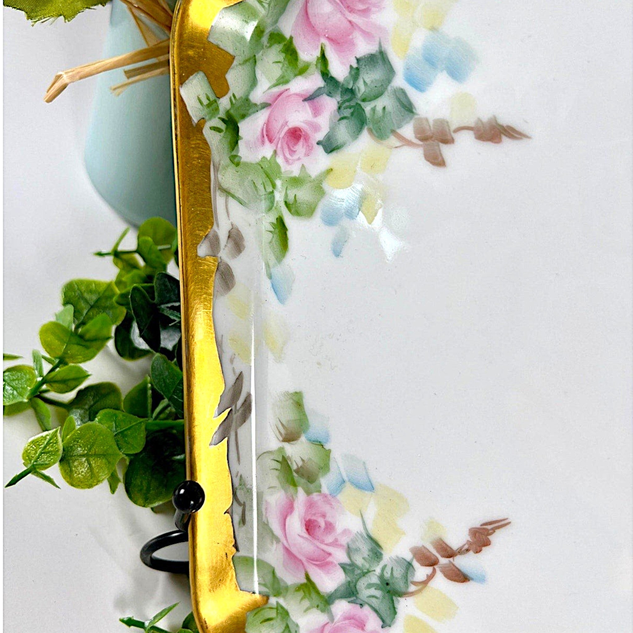 An antique white porcelain octagonal serving platter featuring a delicate gold-gilded rim, presented on a display stand among green foliage. - Photo 4