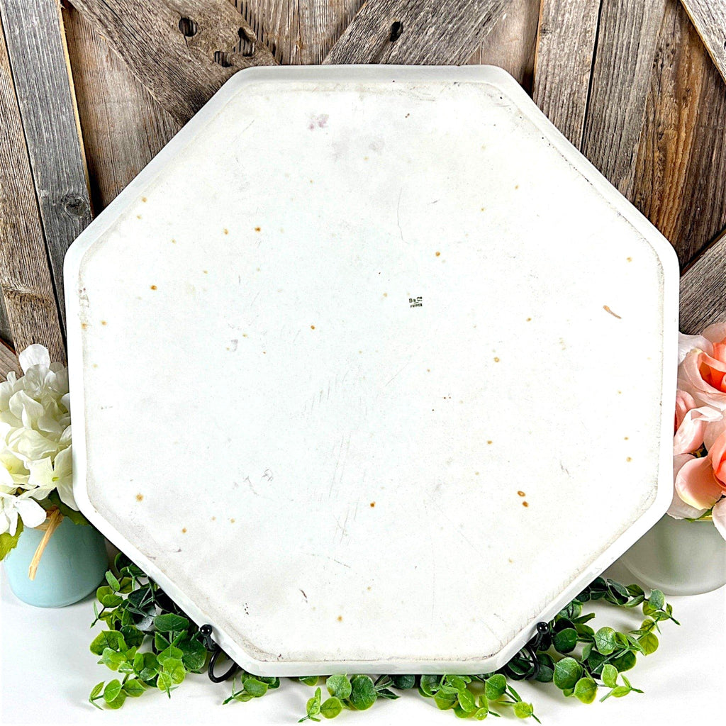 An antique white porcelain octagonal serving platter featuring a delicate gold-gilded rim, presented on a display stand among green foliage. - Photo 6