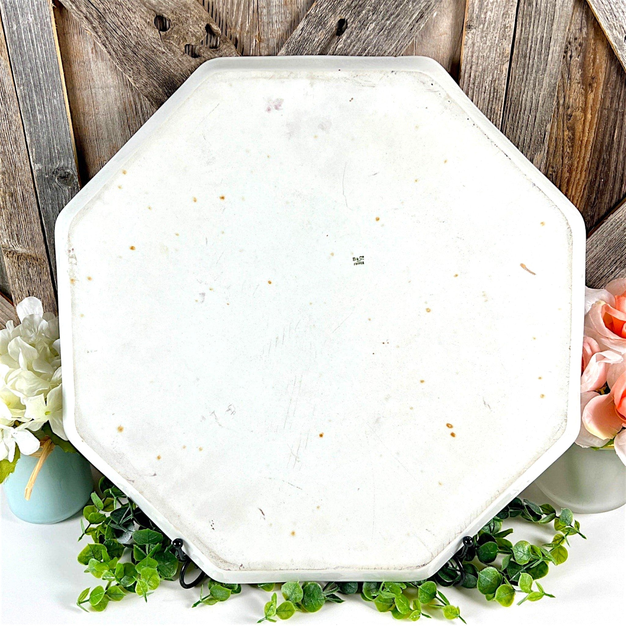 An antique white porcelain octagonal serving platter featuring a delicate gold-gilded rim, presented on a display stand among green foliage. - Photo 6