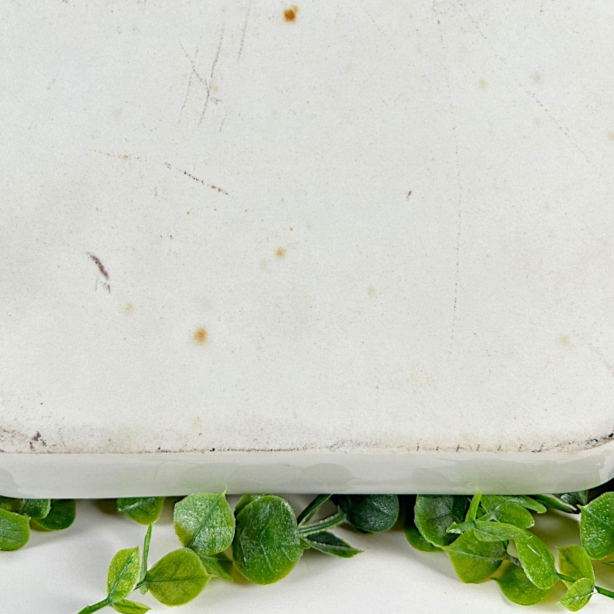 An antique white porcelain octagonal serving platter featuring a delicate gold-gilded rim, presented on a display stand among green foliage. - Photo 8