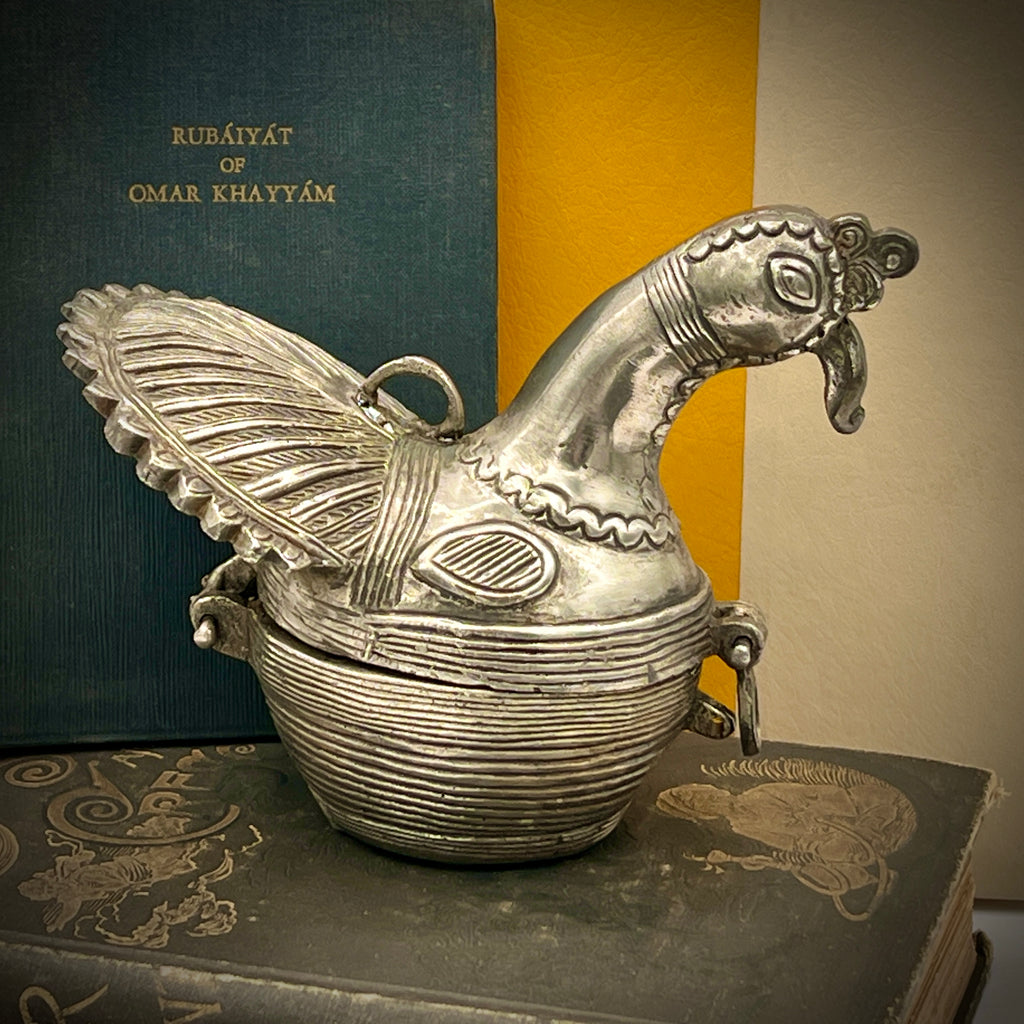 Antique silver-toned, horn-shaped metal vessel shown from a top-down angle with its hinged lid open, revealing a heavily patinated interior with hints of verdigris oxidation. - Photo 1