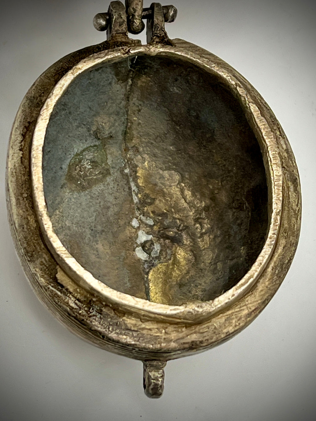 Antique silver-toned, horn-shaped metal vessel shown from a top-down angle with its hinged lid open, revealing a heavily patinated interior with hints of verdigris oxidation. - Photo 6