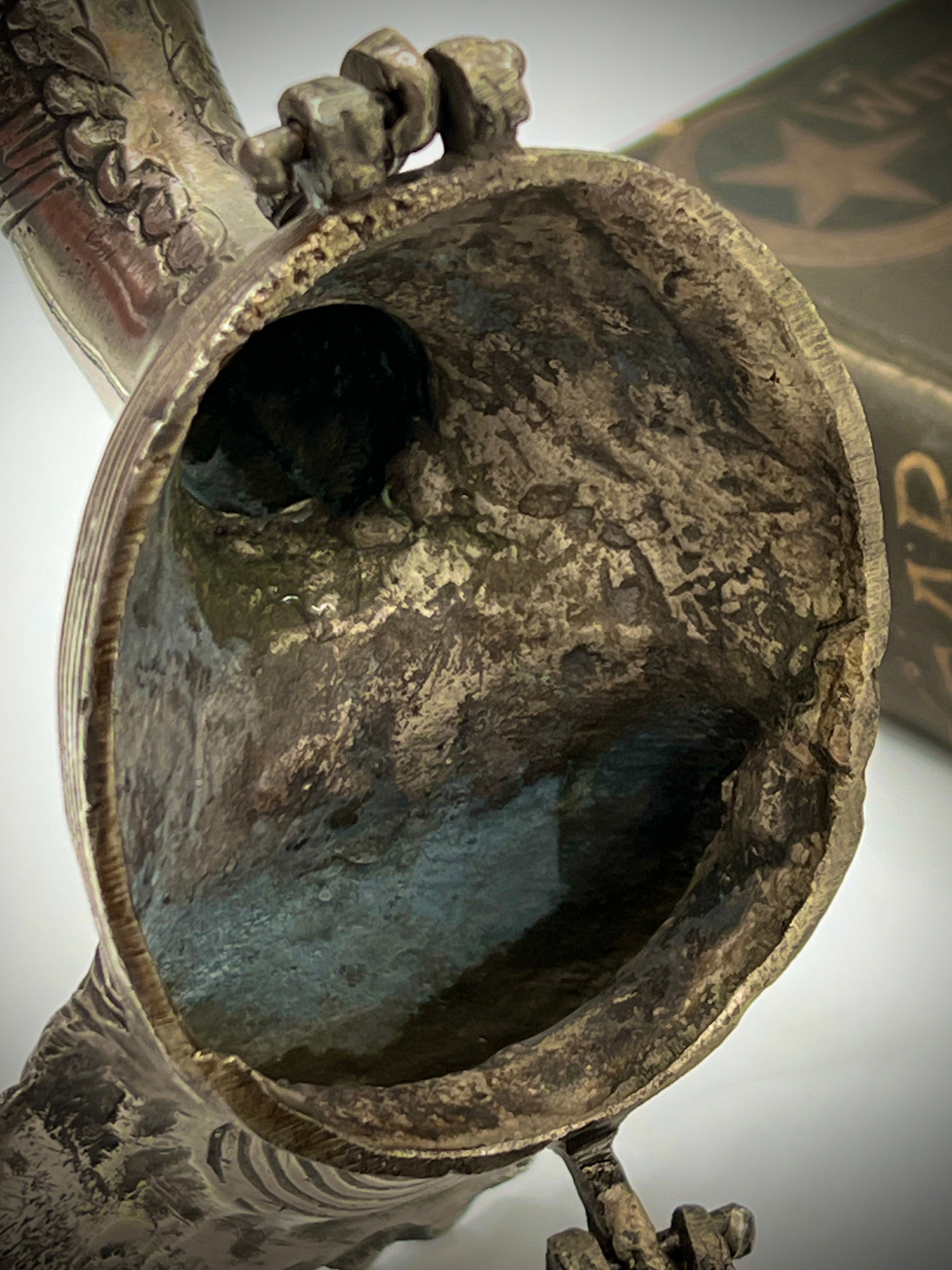 Antique silver-toned, horn-shaped metal vessel shown from a top-down angle with its hinged lid open, revealing a heavily patinated interior with hints of verdigris oxidation. - Photo 7