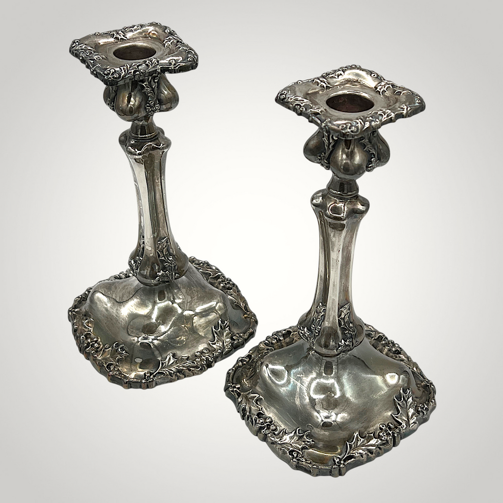 Pair of antique Victorian quadruple silverplate candlesticks with embossed holly leaf and berry relief borders on square contoured bases and fluted stems. - Photo 1