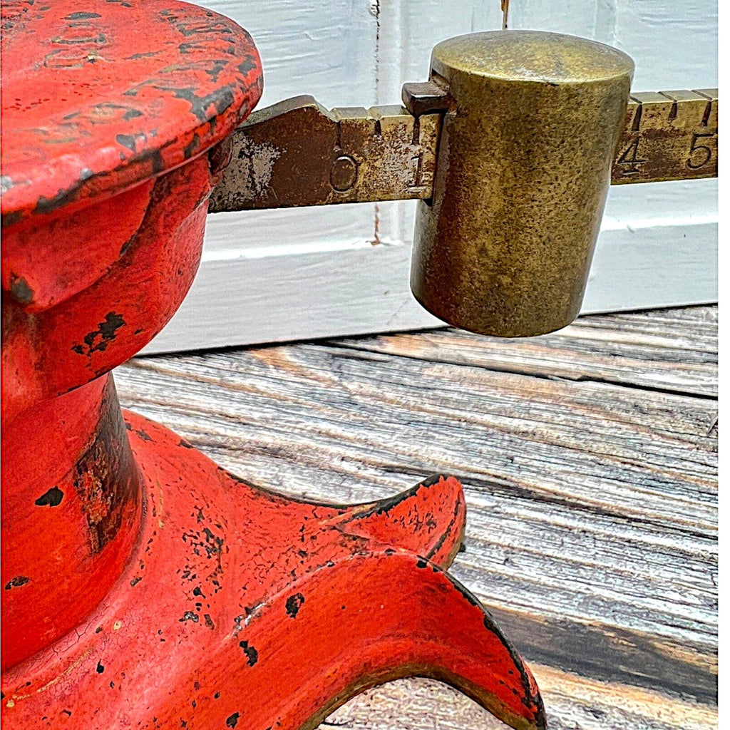 An antique Howe Scale Co. counterbalance scale with a red painted cast iron base and a graduated brass beam holding a solid cylindrical brass slider weight. - Photo 6