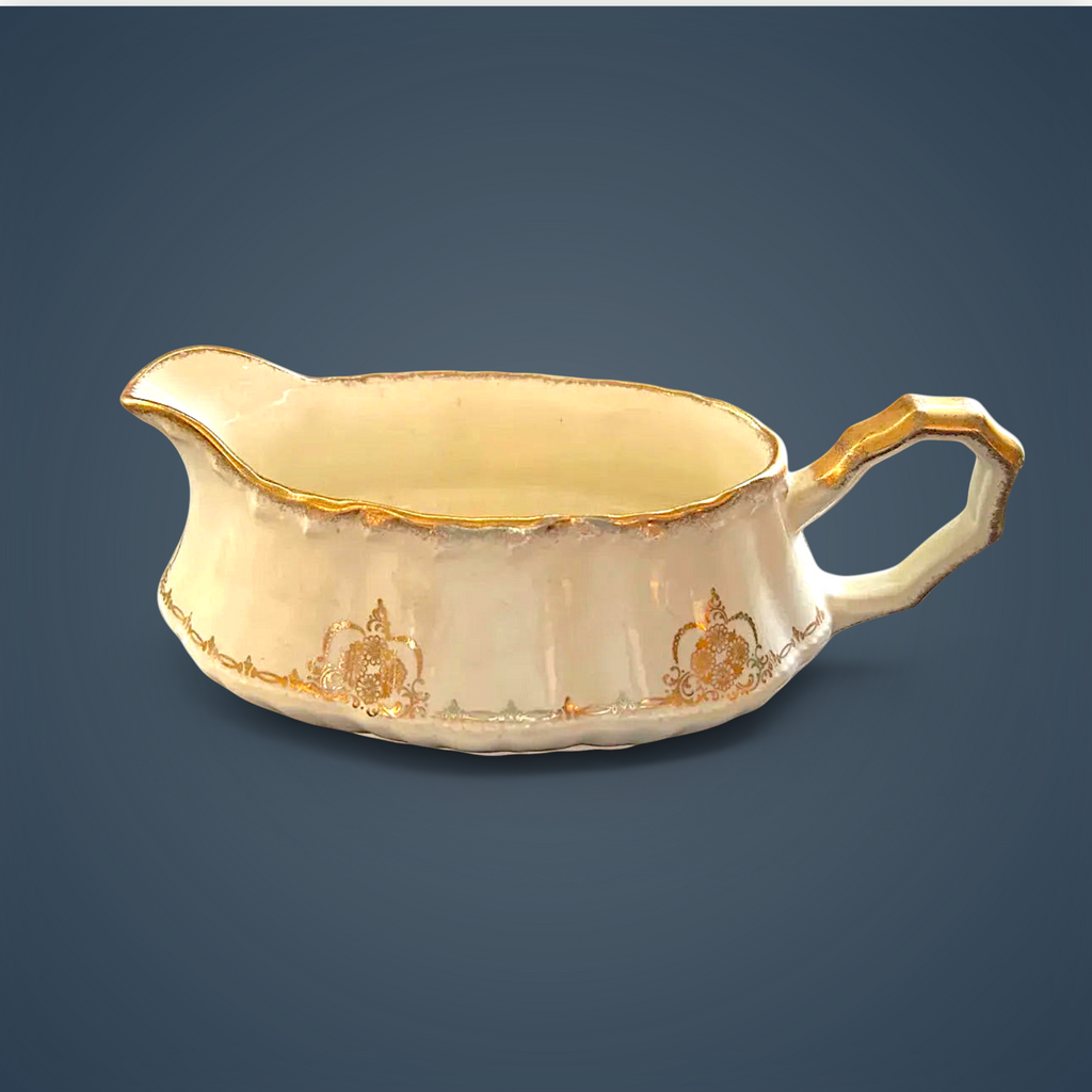 Antique white porcelain gravy boat with an embossed fluted body, scalloped gilded rim, ornate gilded handle, and gold filigree scroll accents along the base. - Photo 2