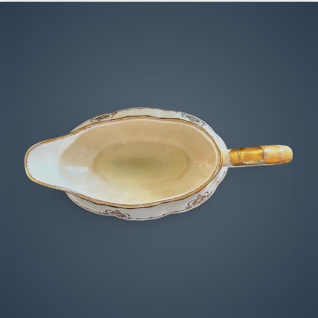 Antique white porcelain gravy boat with an embossed fluted body, scalloped gilded rim, ornate gilded handle, and gold filigree scroll accents along the base. - Photo 3