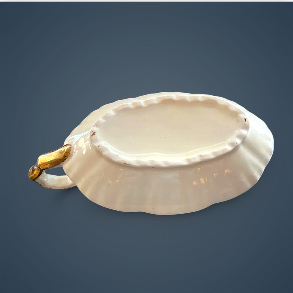 Antique white porcelain gravy boat with an embossed fluted body, scalloped gilded rim, ornate gilded handle, and gold filigree scroll accents along the base. - Photo 5