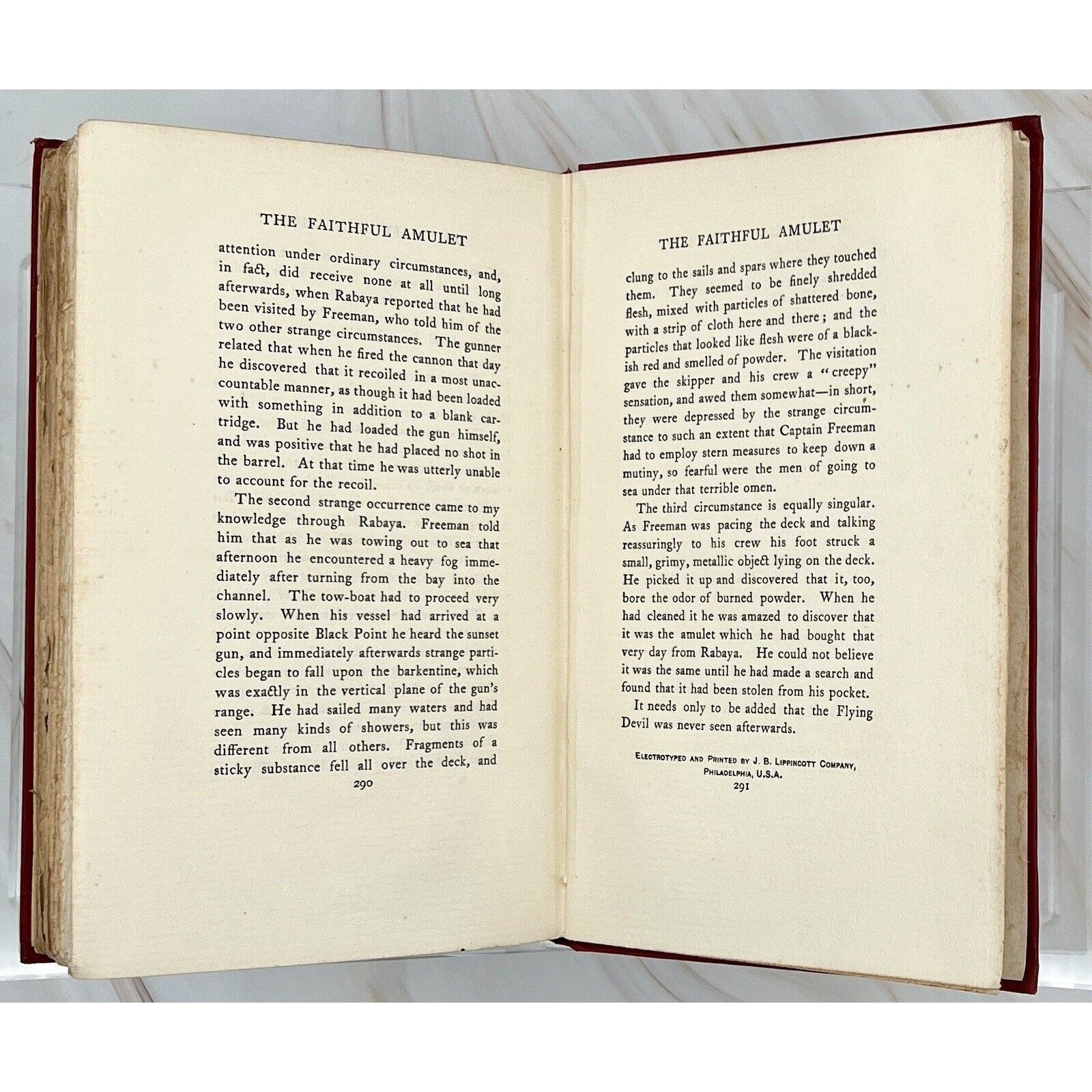 Open antique hardcover showing The Faithful Amulet, rare 19th-century edition with Gothic serif text.