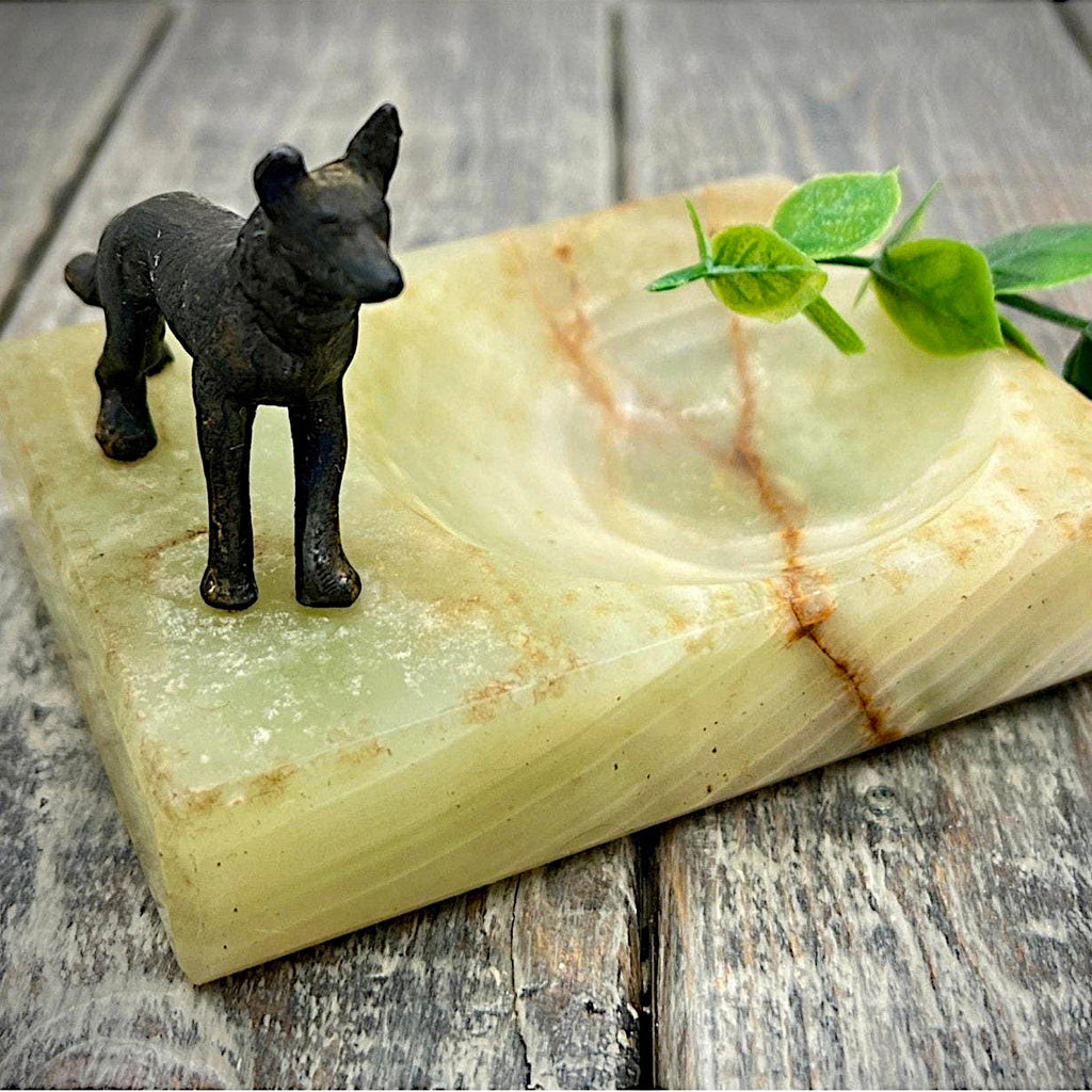 An Art Deco green onyx trinket dish featuring a detailed dark patinated metal figurine of a standing German Shepherd dog mounted on the corner of the polished translucent green stone base. - Photo 1