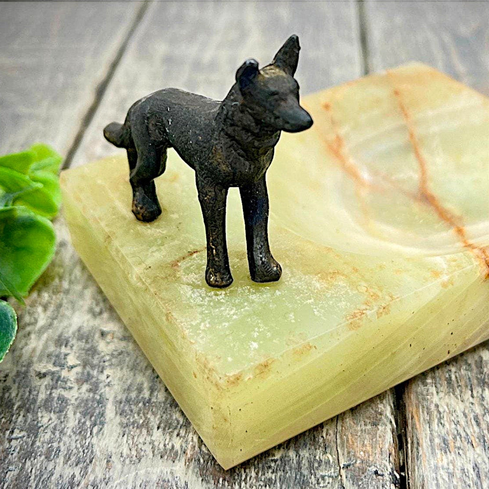 An Art Deco green onyx trinket dish featuring a detailed dark patinated metal figurine of a standing German Shepherd dog mounted on the corner of the polished translucent green stone base. - Photo 8