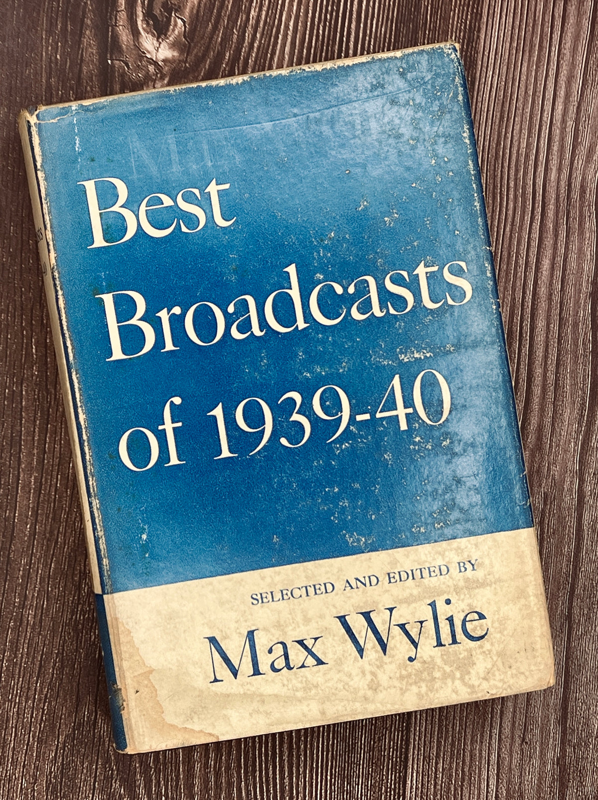 Hardcover book Best Broadcasts of 1939-40 featuring a two-tone cloth binding with an off-white upper half depicting a black line art radio microphone above a solid navy blue lower cloth cover. - Photo 1