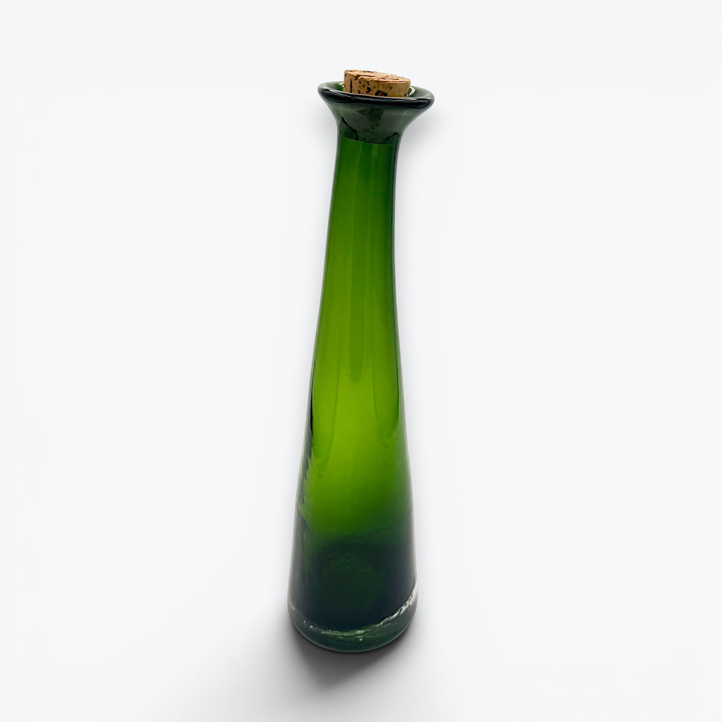 A tall, tapered mid-century green glass decanter with a flared rim and cork stopper, standing against a clean white background. - Photo 2