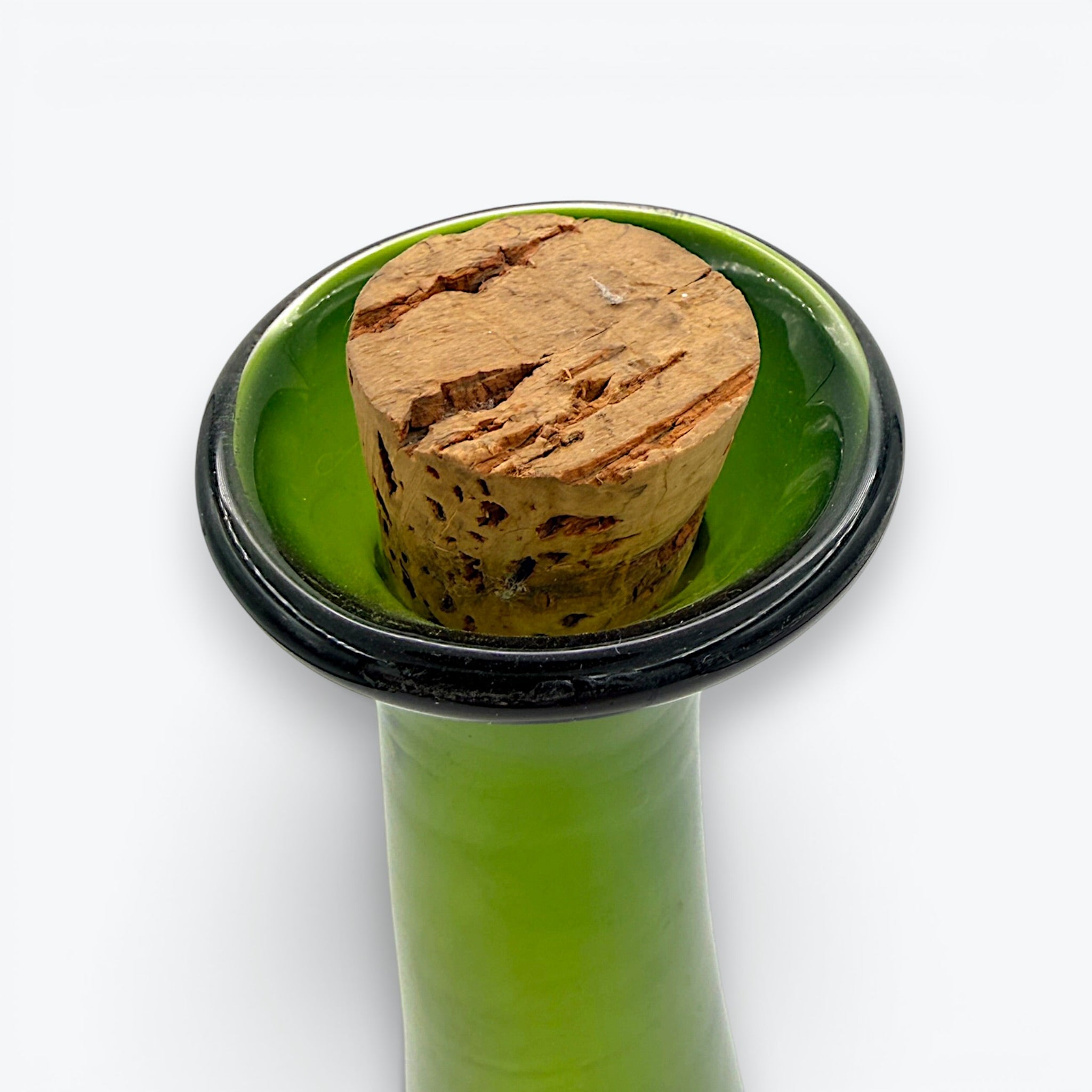 A tall, tapered mid-century green glass decanter with a flared rim and cork stopper, standing against a clean white background. - Photo 3
