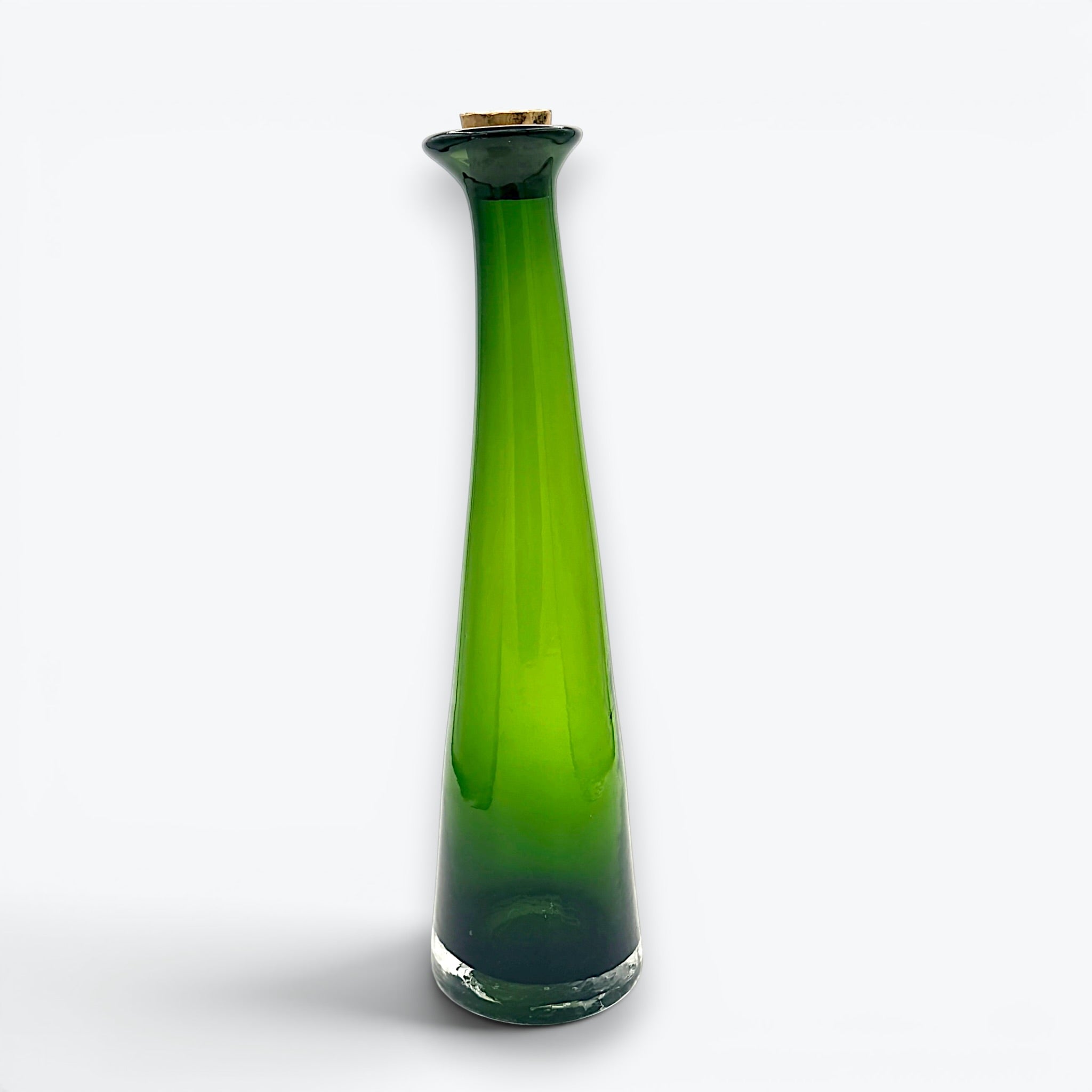 A tall, tapered mid-century green glass decanter with a flared rim and cork stopper, standing against a clean white background. - Photo 6