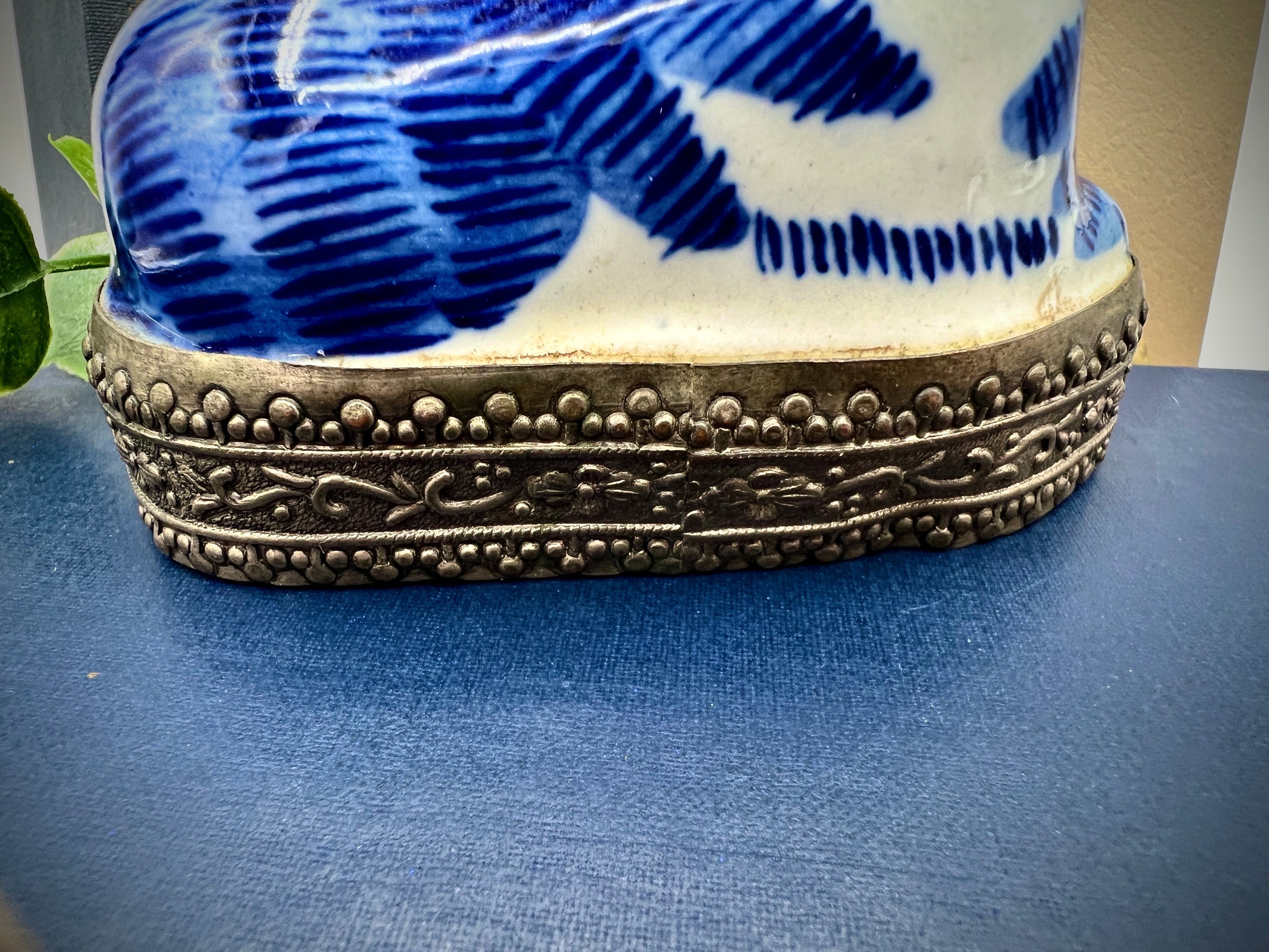 A vintage blue and white glazed porcelain cat figurine with cobalt blue painted patterns resting on an ornate embossed metal gallery base. - Photo 5