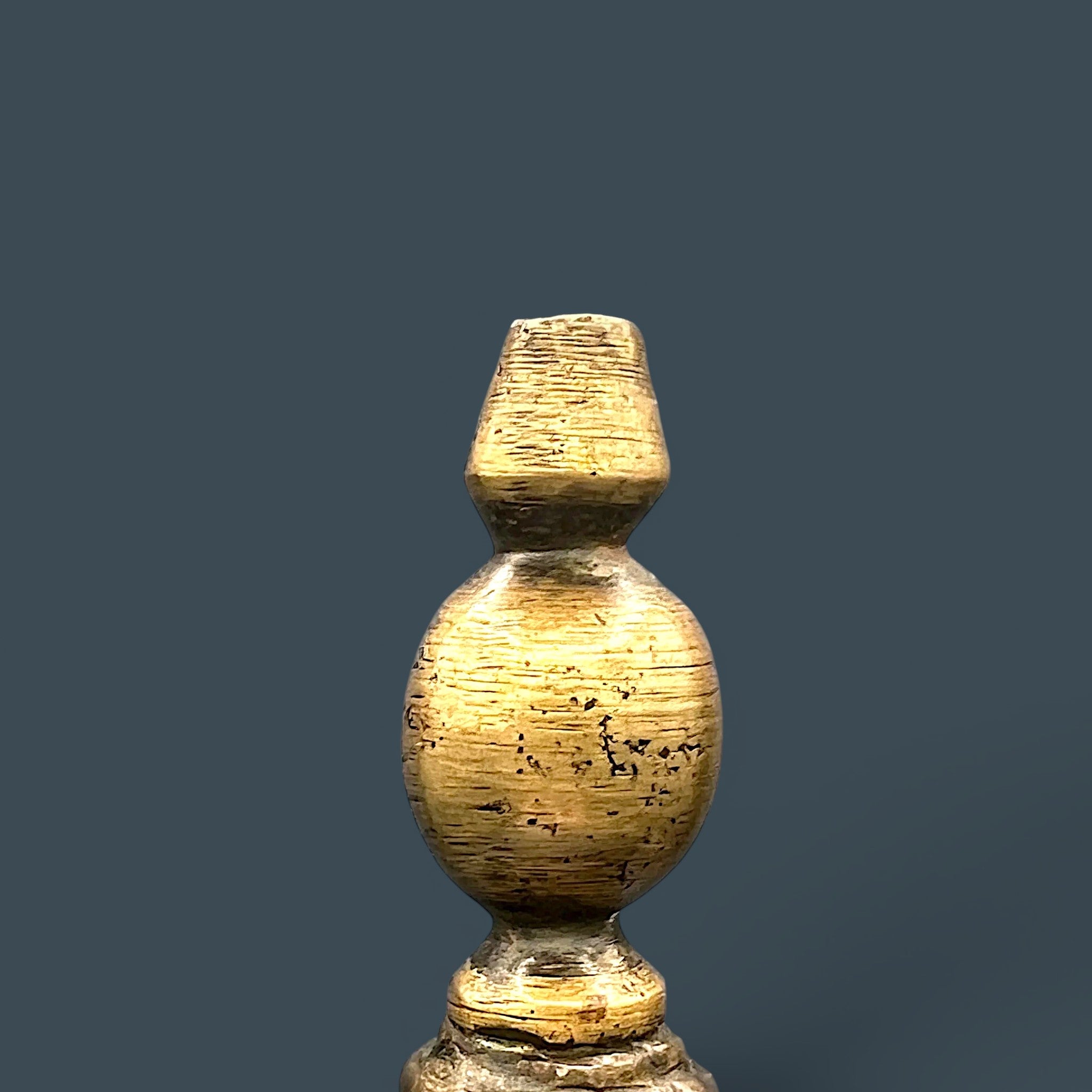 An antique hand-forged brass pitcher with a tapered neck and warm golden-brown patina, displayed against a dark background. - Photo 4