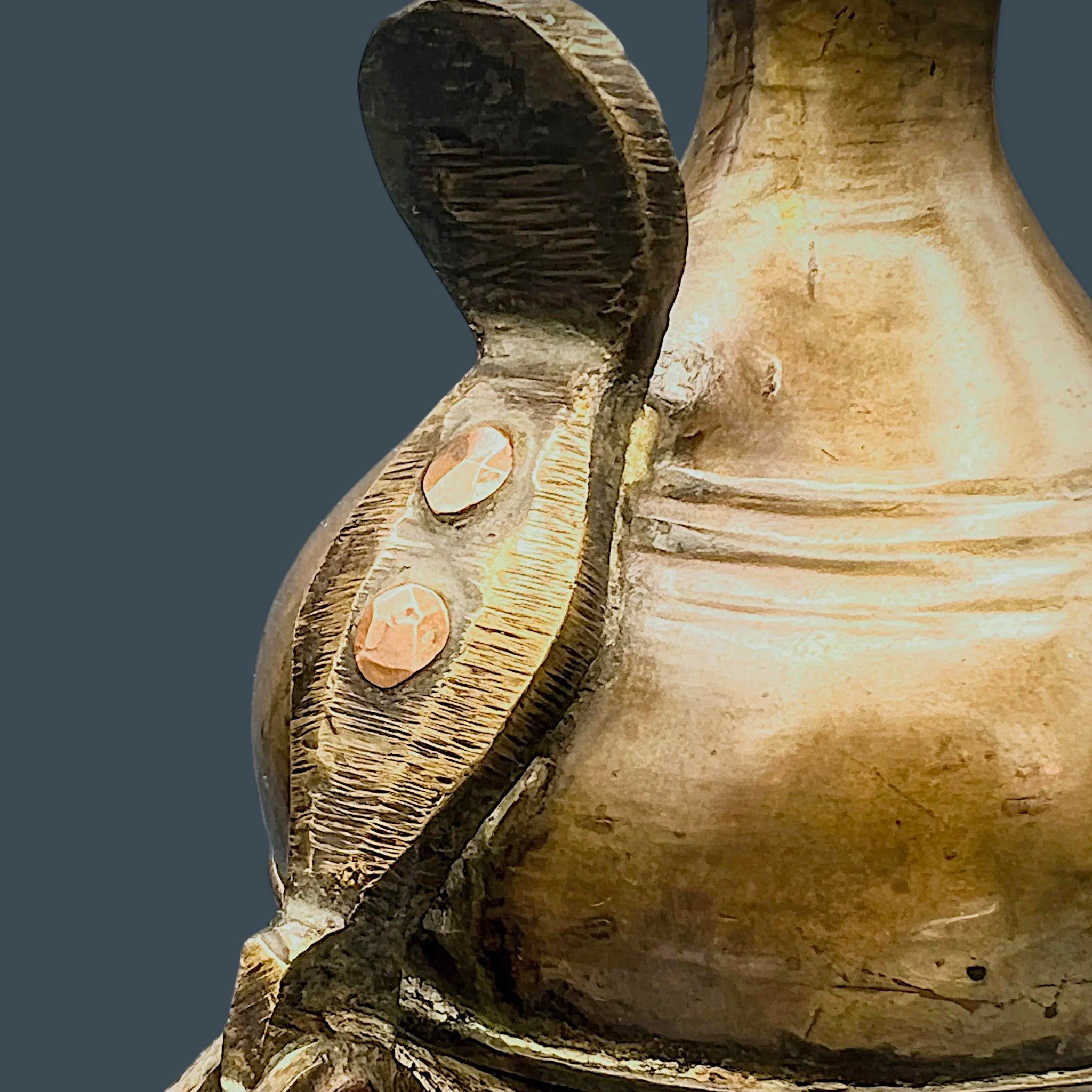 An antique hand-forged brass pitcher with a tapered neck and warm golden-brown patina, displayed against a dark background. - Photo 6