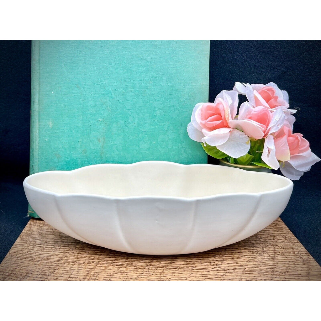 Haeger 3905 oblong white ceramic bowl with a wavy rim on a wood surface.