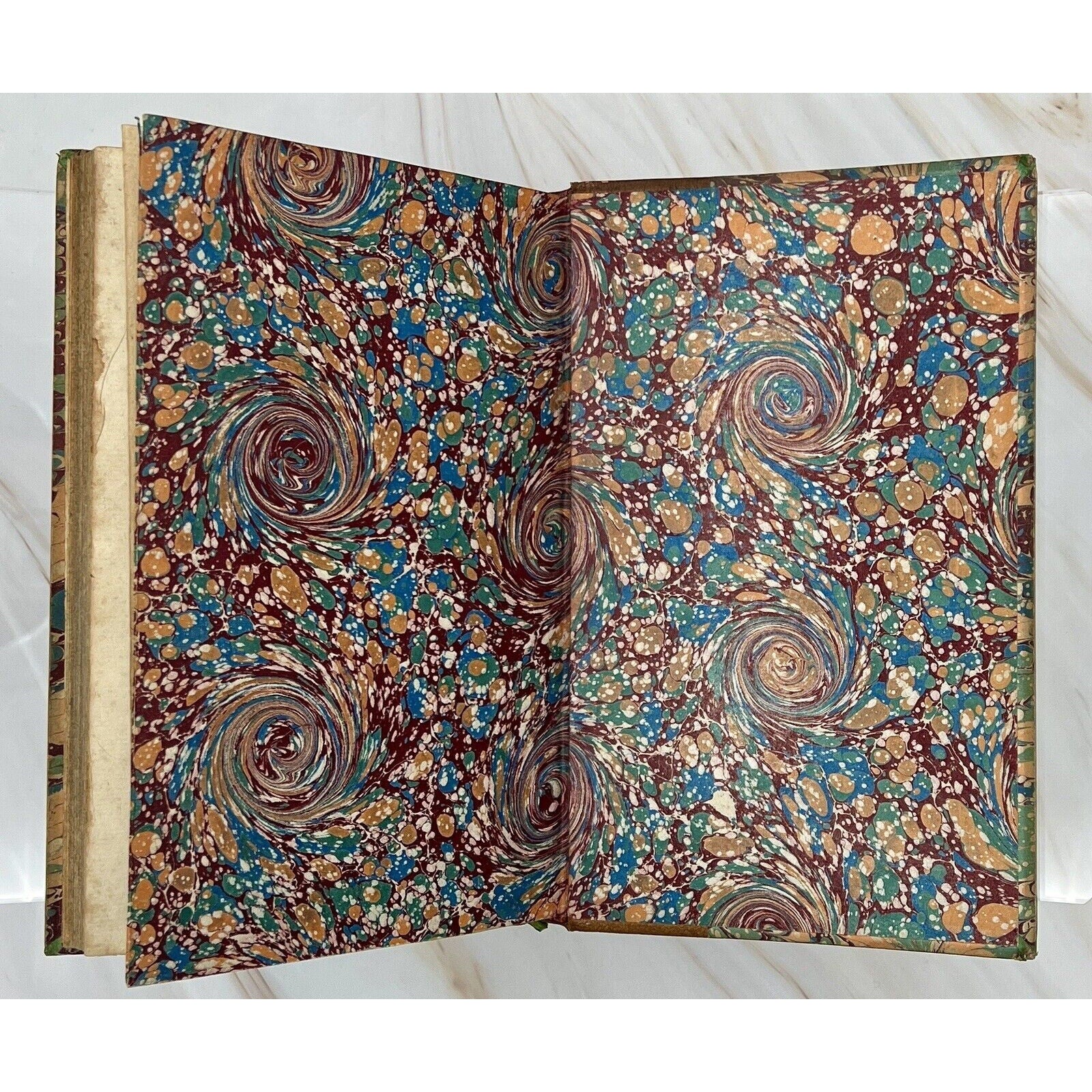 Colorful marbled endpapers from Errotika Biblion by de Mirabeau, 1783 first edition, leather-bound antique book.