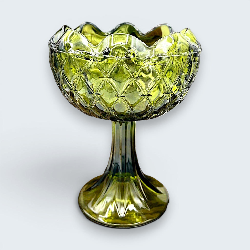 A vintage avocado green pressed glass compote bowl featuring a deeply textured diamond point pattern, a scalloped rim, and a tall, ribbed pedestal base. - Photo 1